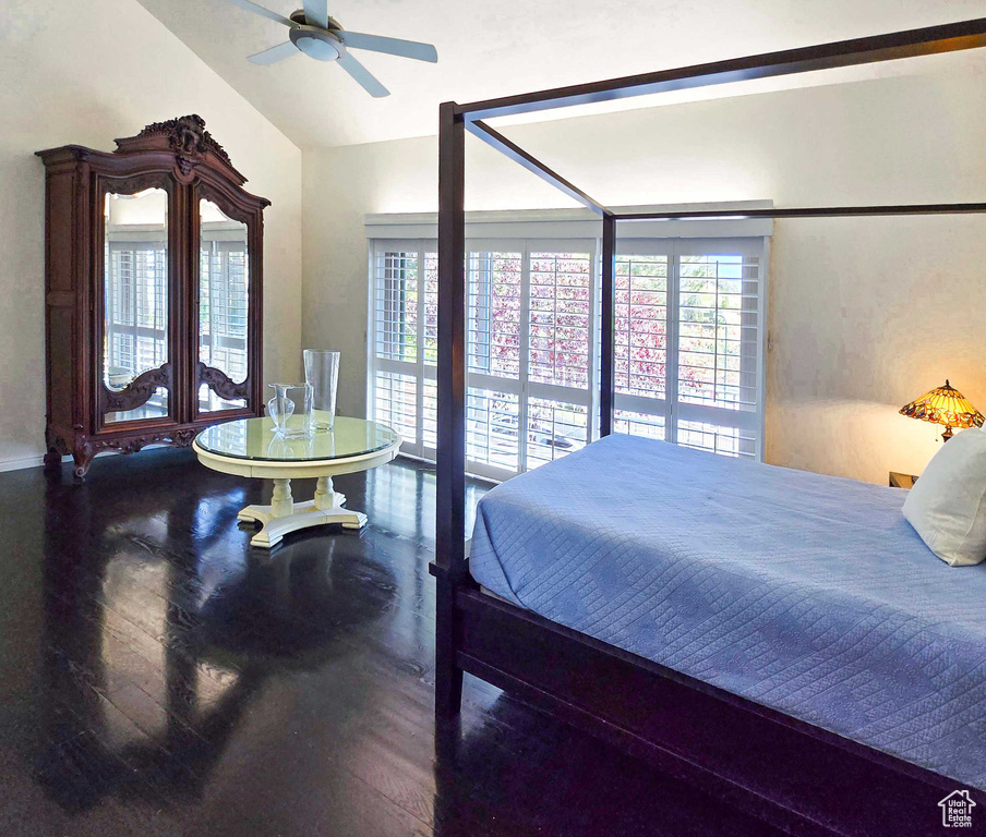 Bedroom featuring hardwood / wood-style flooring, ceiling fan, and vaulted ceiling