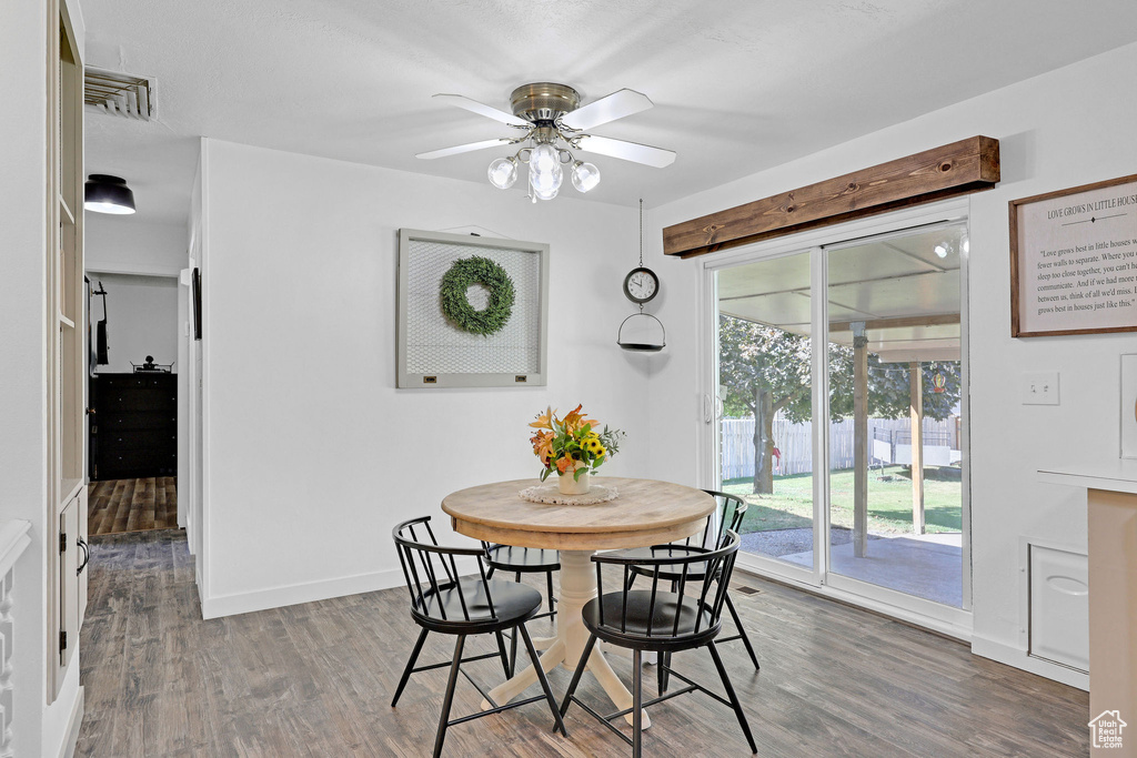 Dining room with ceiling fan and hardwood / wood-style flooring