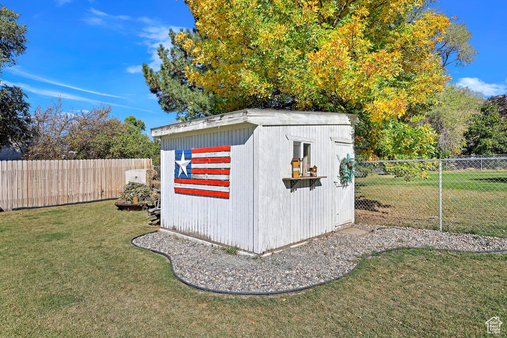 View of outdoor structure with a lawn