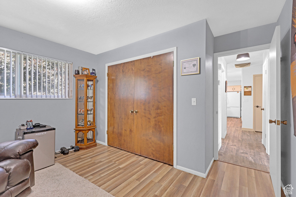 Living area with wood-type flooring and a textured ceiling