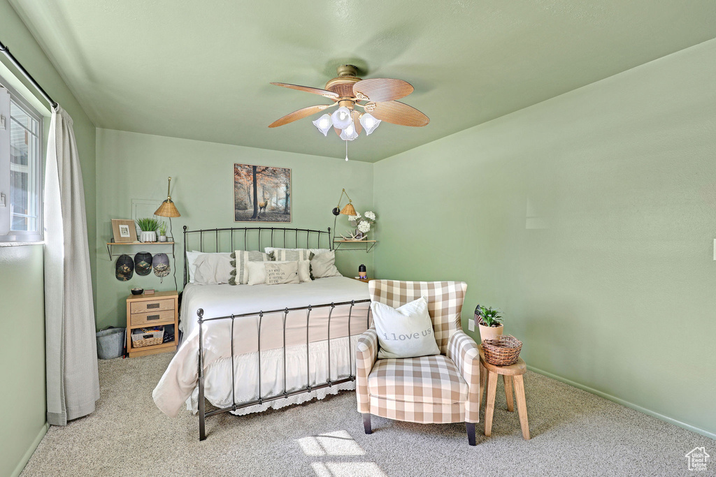 Bedroom featuring ceiling fan and carpet flooring