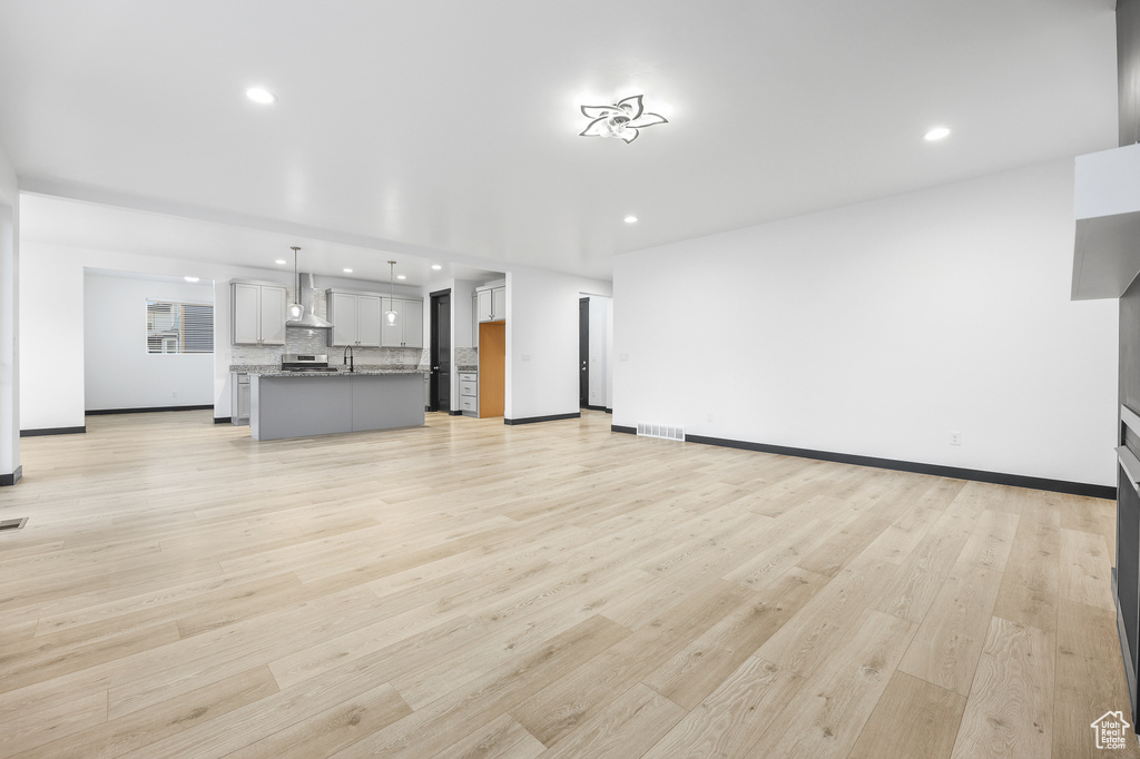 Unfurnished living room with light hardwood / wood-style floors