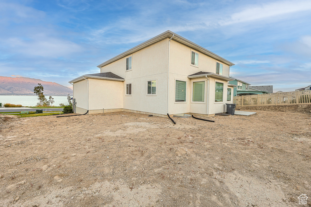 Rear view of property featuring a water and mountain view