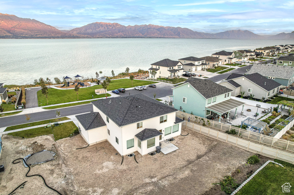 Birds eye view of property featuring a water and mountain view