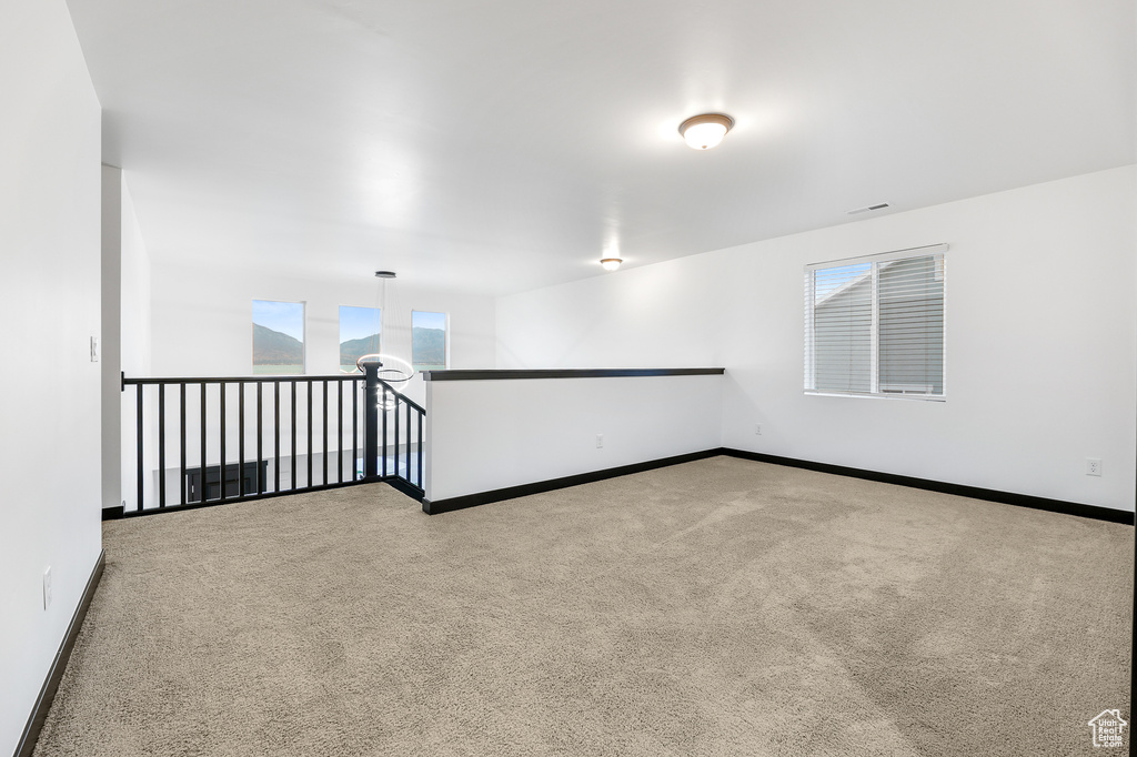 Spare room with light colored carpet and plenty of natural light