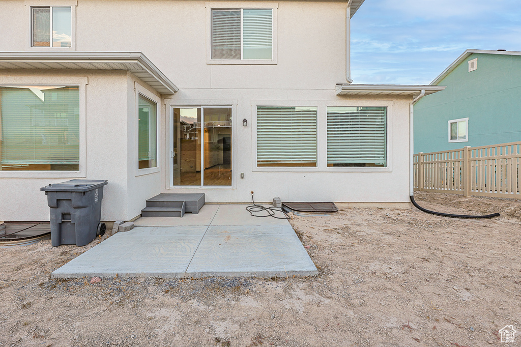 Back of house with a patio