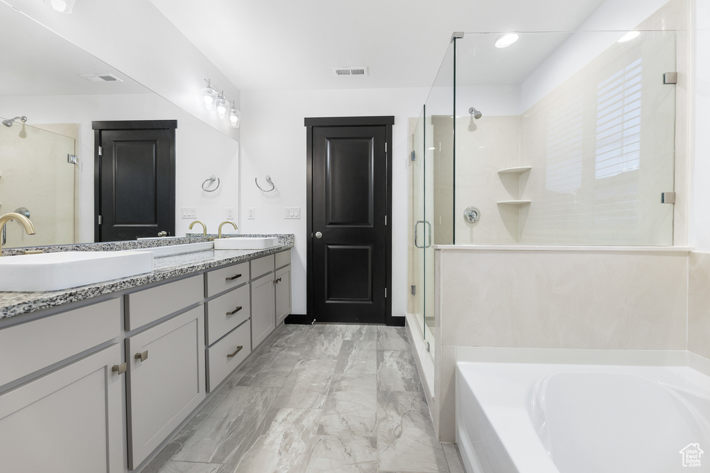 Bathroom with vanity and shower with separate bathtub