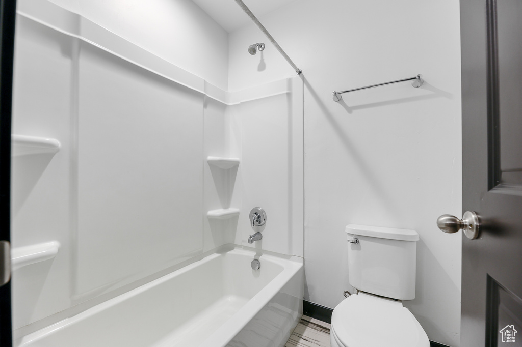 Bathroom with shower / washtub combination and toilet