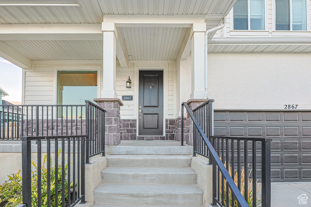 View of exterior entry with a garage