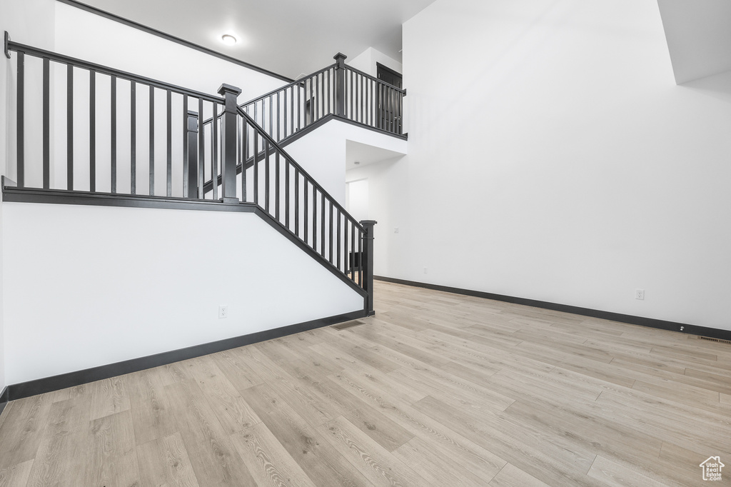 Stairway featuring hardwood / wood-style floors