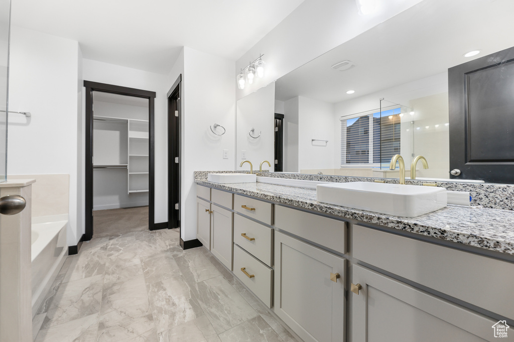 Bathroom featuring a bath and vanity