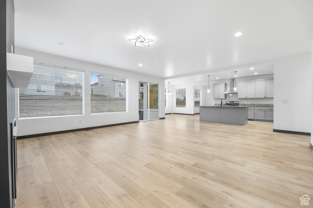 Unfurnished living room with light hardwood / wood-style floors