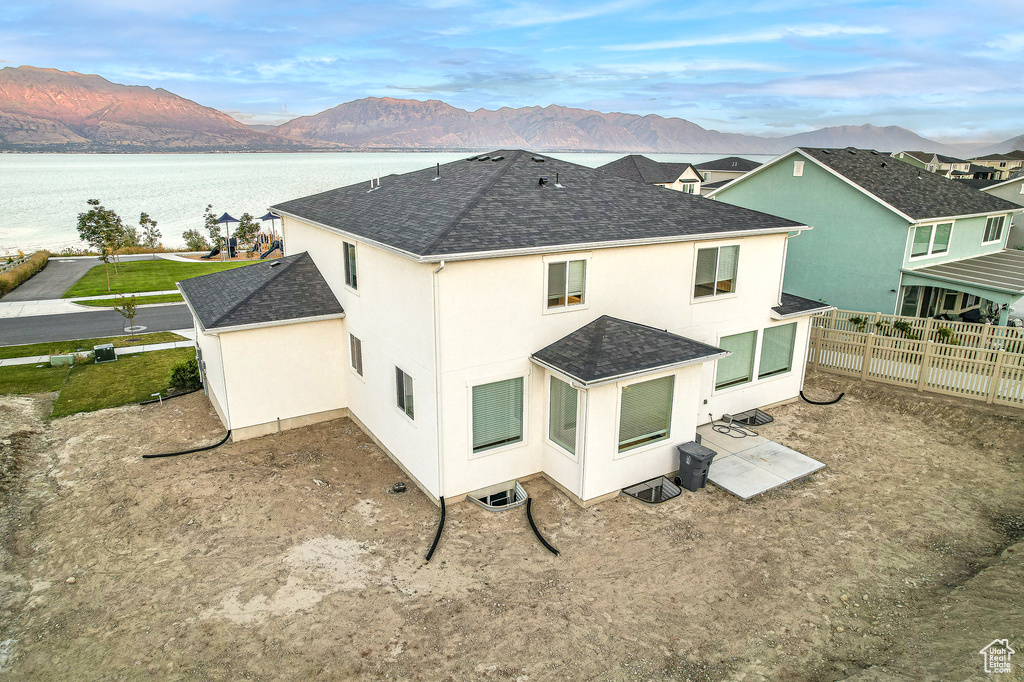 Rear view of property featuring a water and mountain view