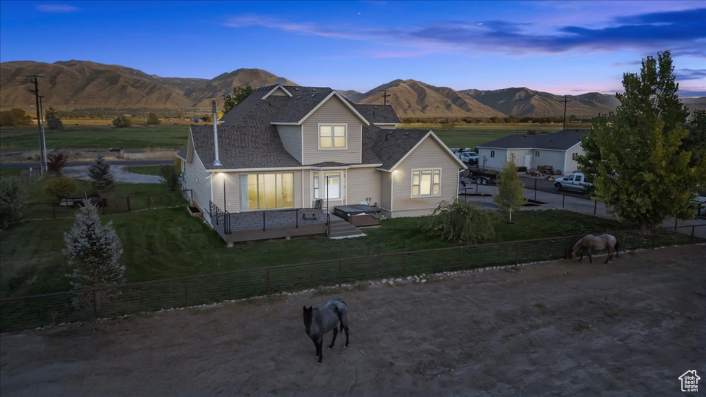 View of front of house featuring a deck with mountain view