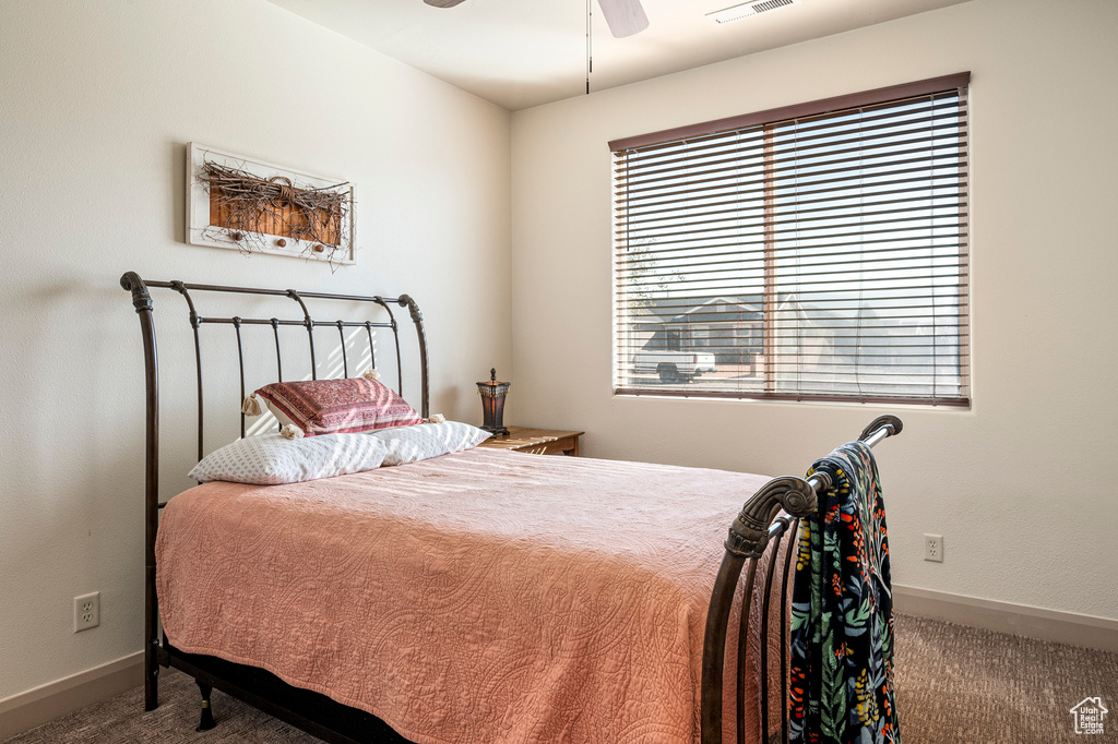 Bedroom with ceiling fan and carpet flooring