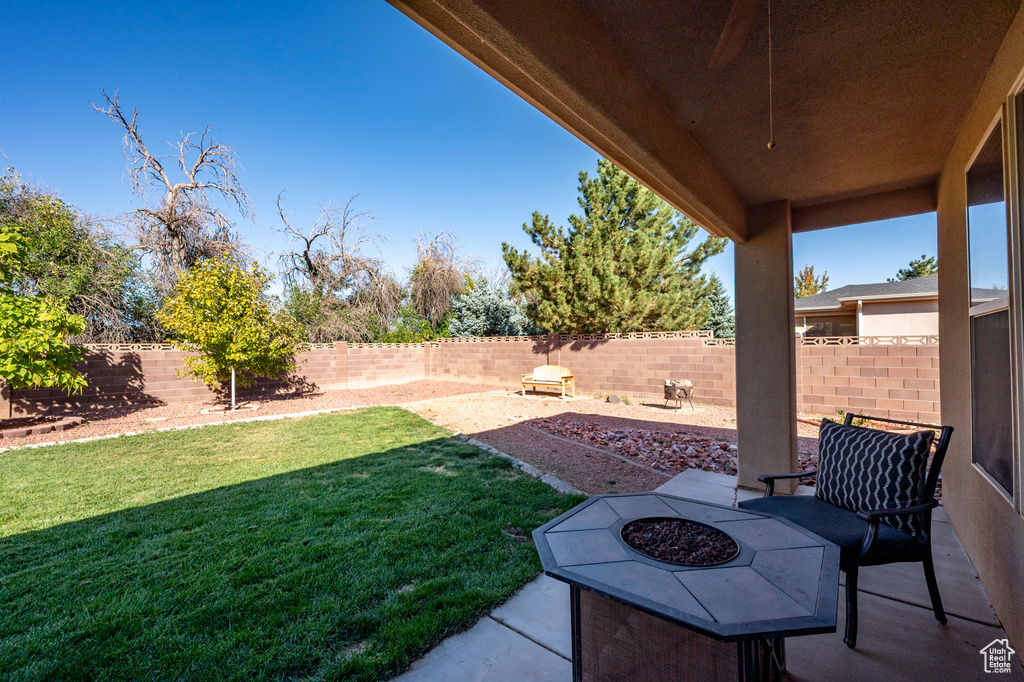 View of yard with a patio and an outdoor fire pit