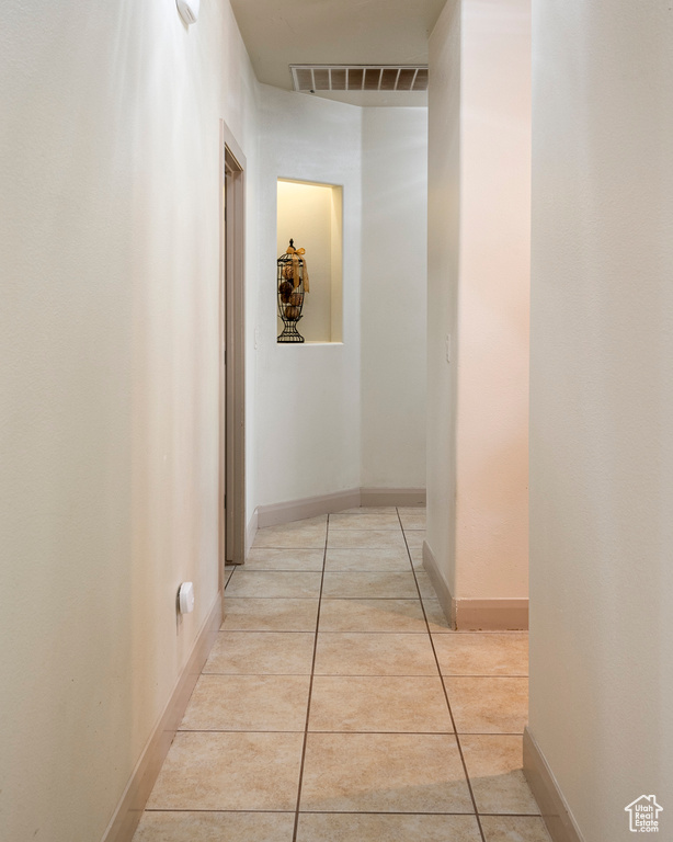 Hall featuring light tile patterned floors