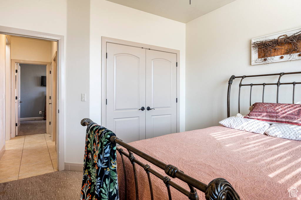 Tiled bedroom featuring a closet