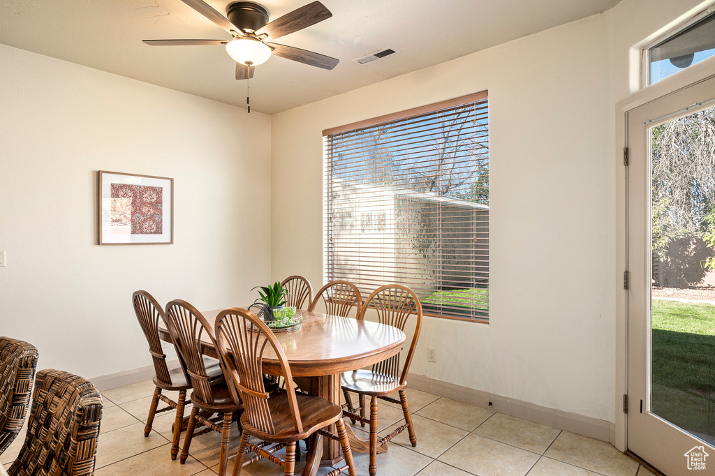 Dining area featuring ceiling fan and light tile patterned floors