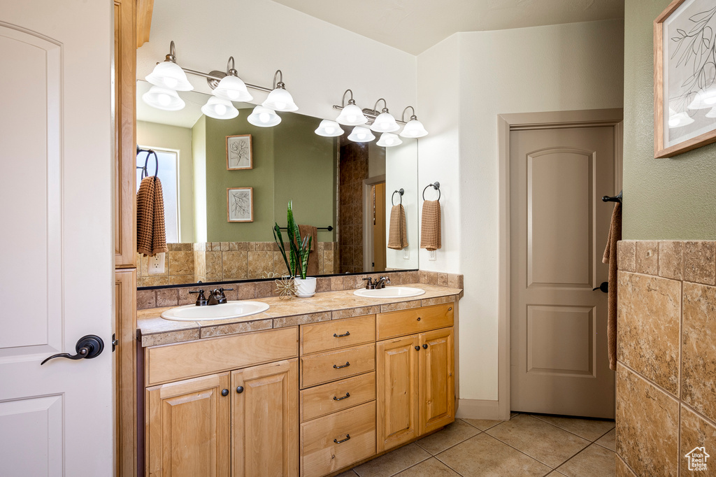 Bathroom with tile patterned floors and vanity