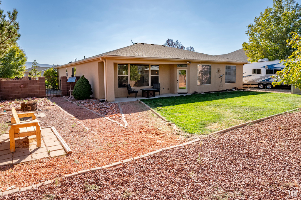 Rear view of house featuring a lawn and a patio area