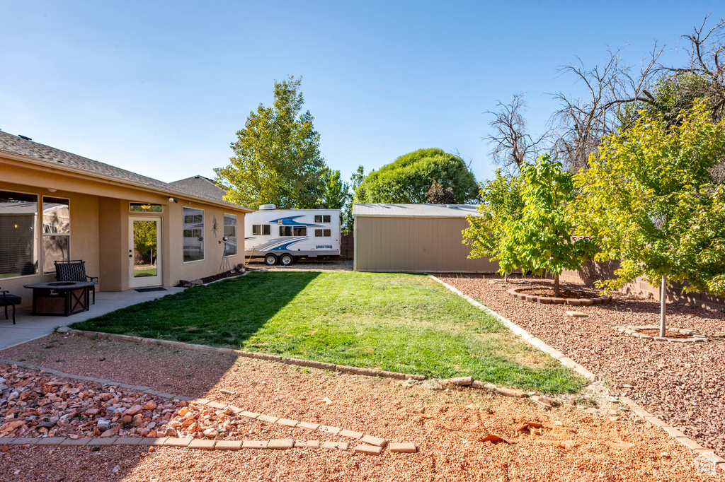 View of yard with a fire pit and a patio area