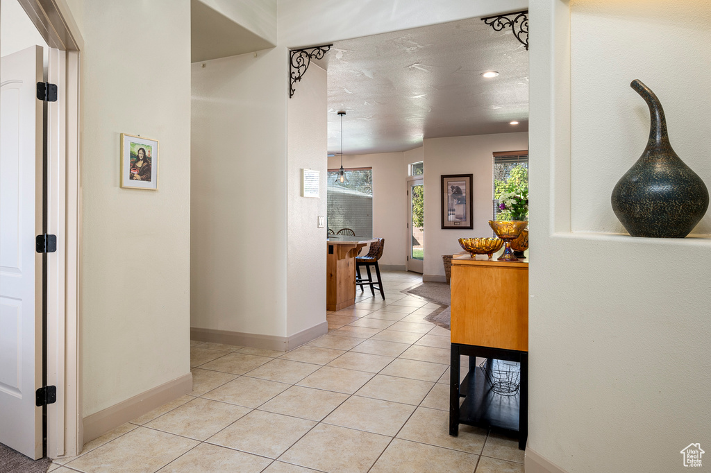 Hallway with light tile patterned floors