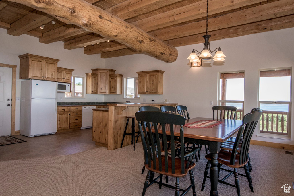 Dining space with beam ceiling, wooden ceiling, and a wealth of natural light