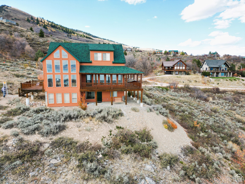 Rear view of property featuring a deck with mountain view