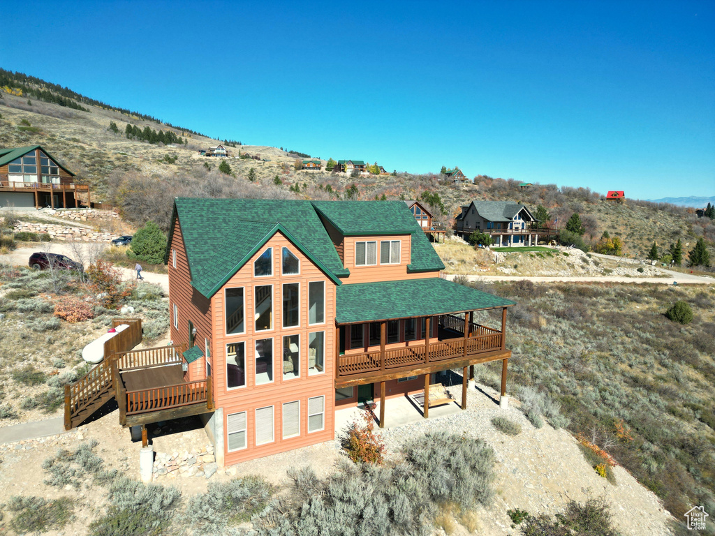 Rear view of property featuring a deck with mountain view