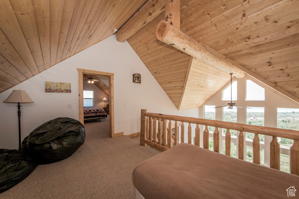 Hallway featuring wood ceiling, beamed ceiling, high vaulted ceiling, and carpet flooring