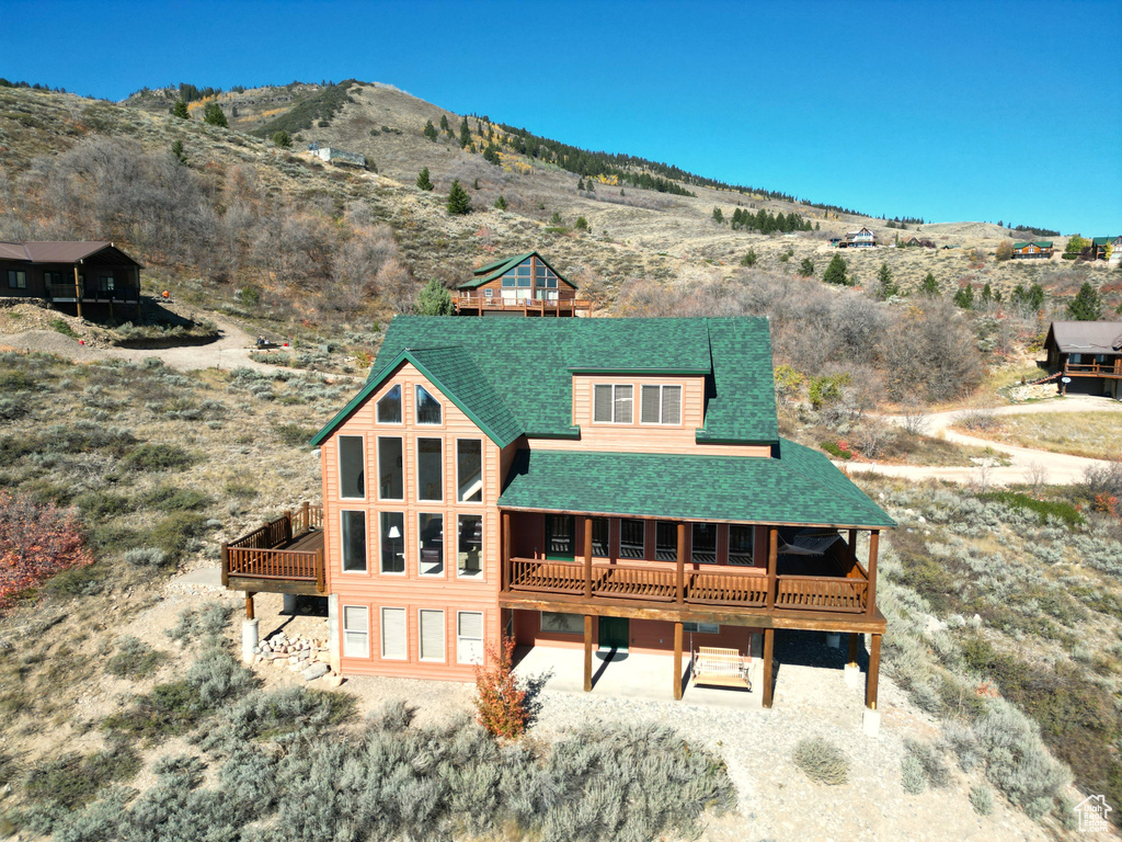 Rear view of house featuring a mountain view