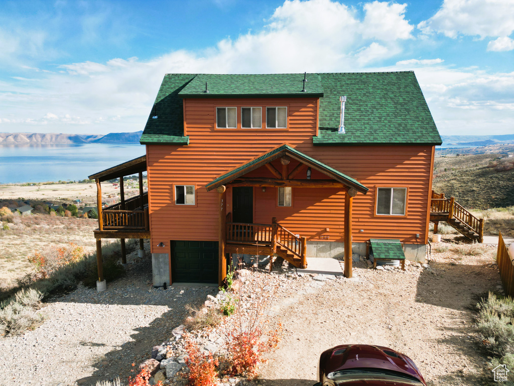 Log home with a mountain view and a garage