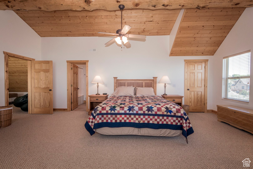 Carpeted bedroom with ceiling fan, wood ceiling, and high vaulted ceiling