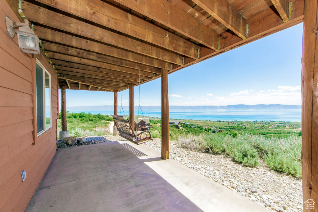 View of patio featuring a water and mountain view