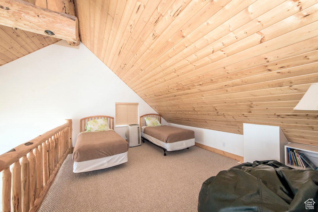 Bedroom with carpet floors, wood ceiling, and vaulted ceiling