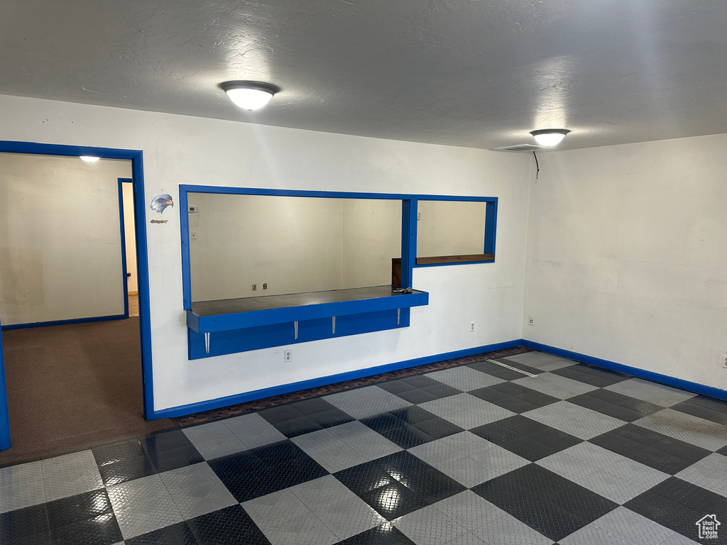 Unfurnished room featuring a textured ceiling