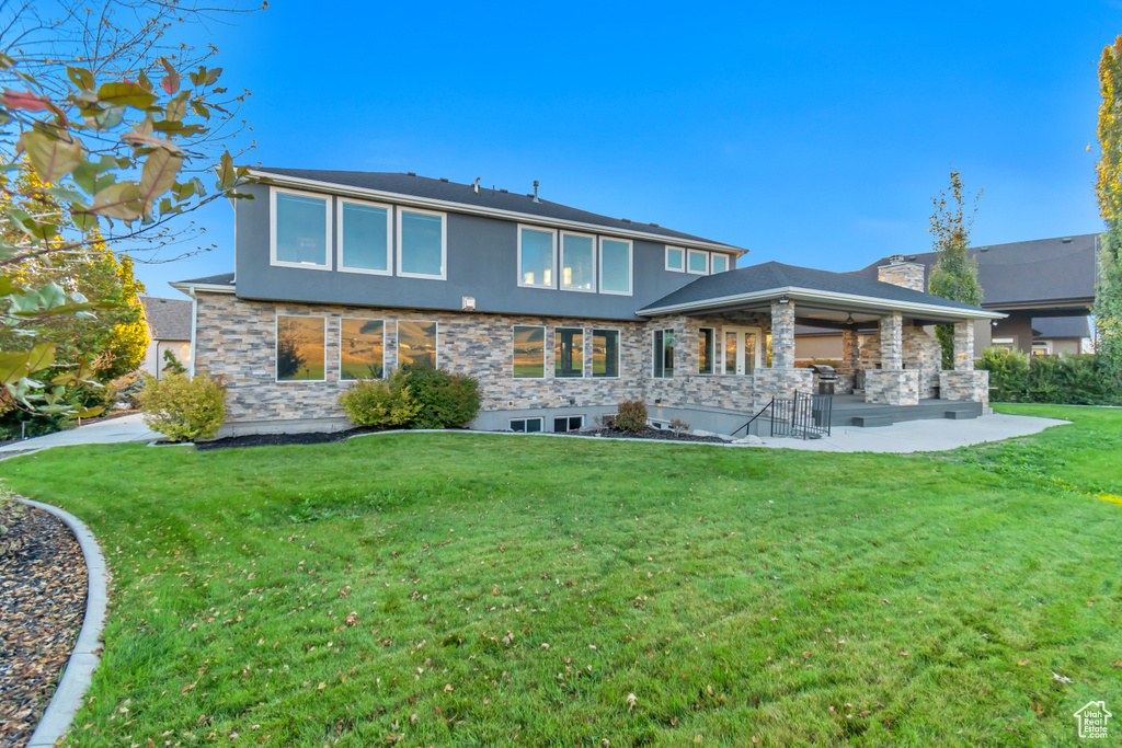 Back of house featuring a patio and a lawn