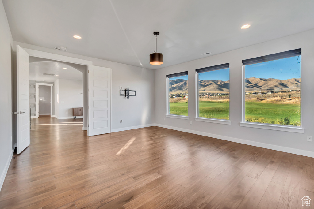 Empty room featuring hardwood / wood-style flooring and radiator