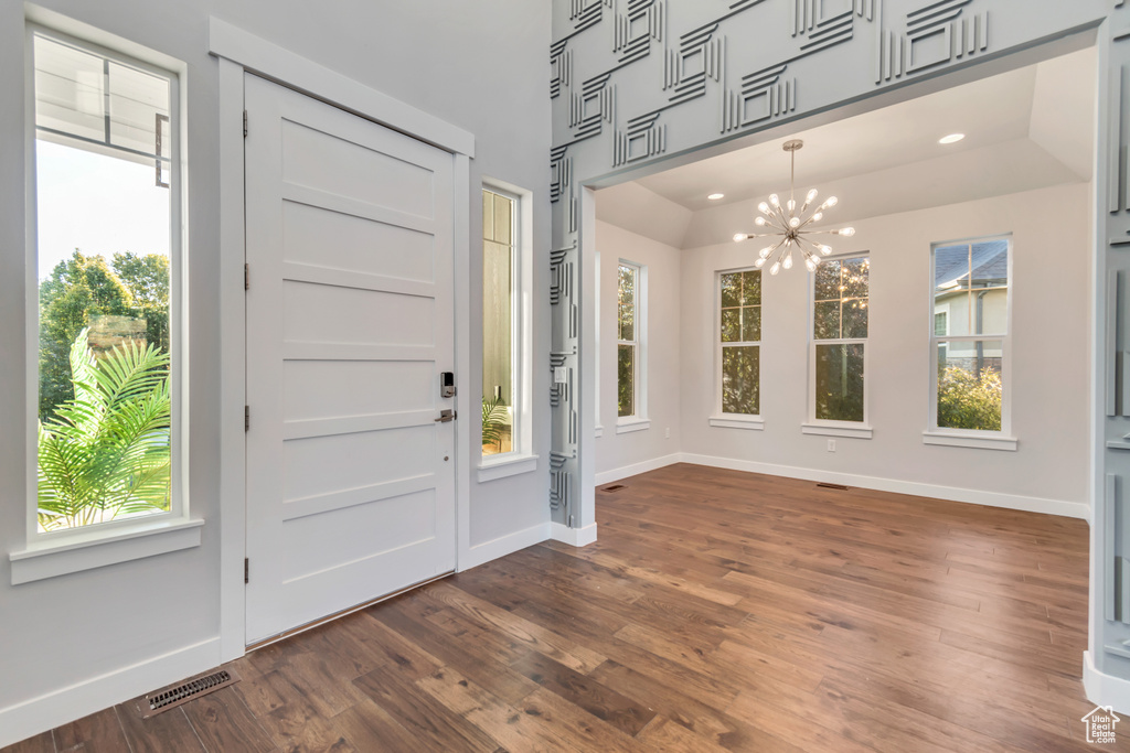 Entrance foyer with dark wood-type flooring and a wealth of natural light