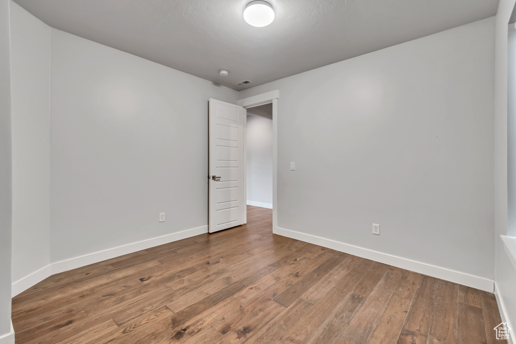 Spare room with hardwood / wood-style floors