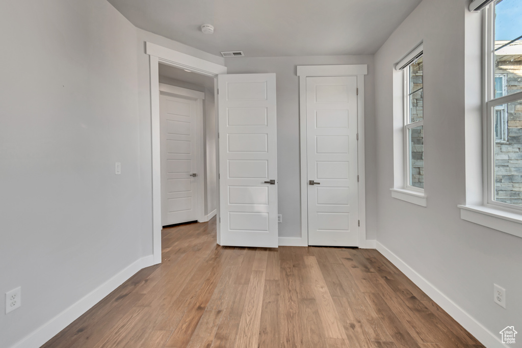 Unfurnished bedroom featuring light wood-type flooring