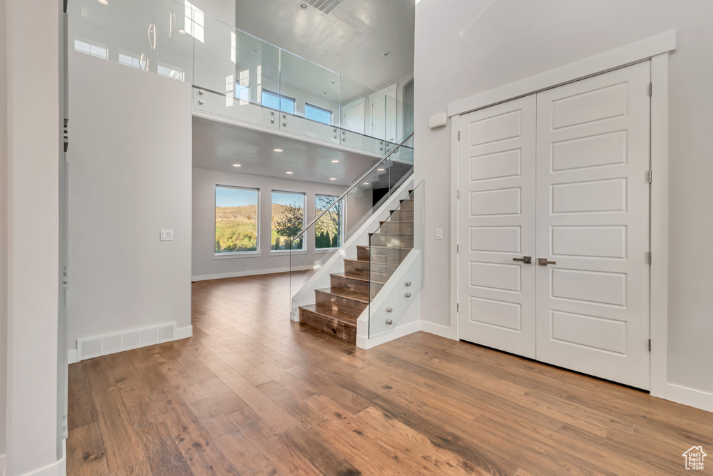 Foyer entrance with hardwood / wood-style floors