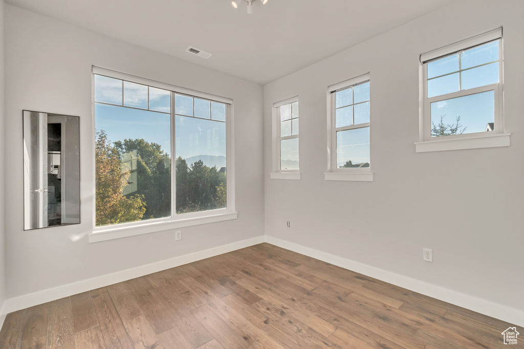 Spare room featuring wood-type flooring