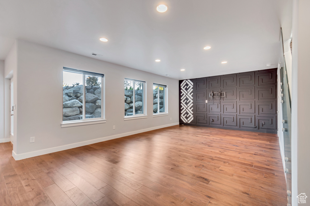 Unfurnished living room featuring wood-type flooring