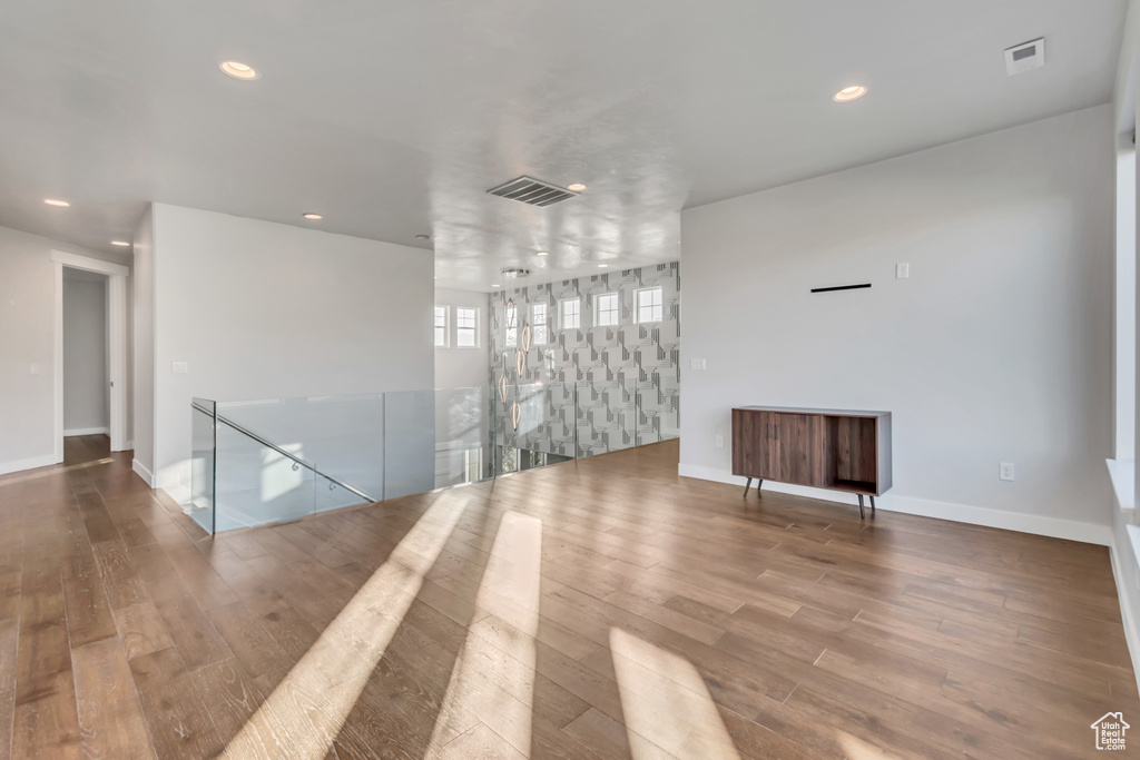 Empty room with hardwood / wood-style flooring