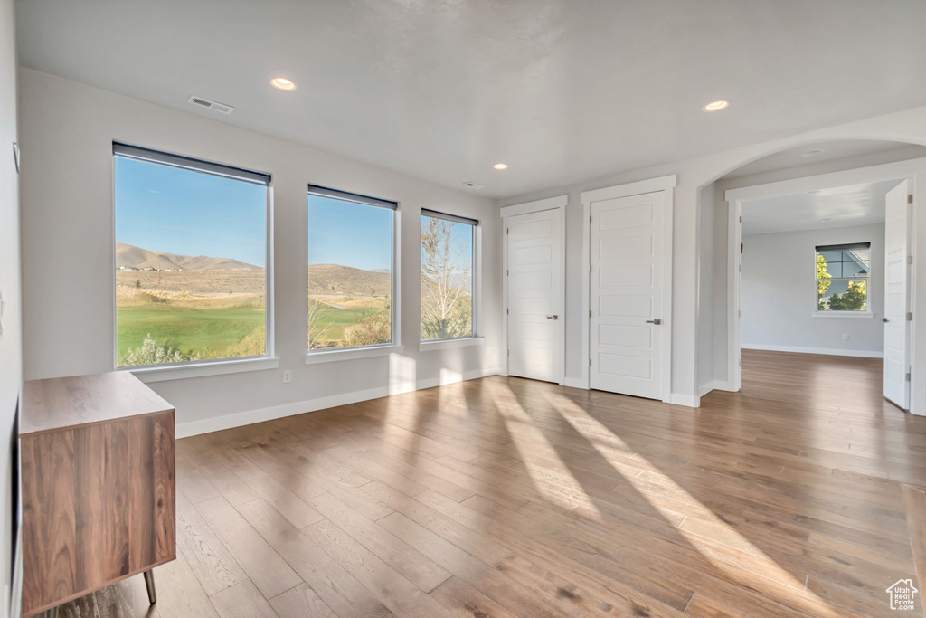 Interior space featuring hardwood / wood-style flooring, multiple windows, and a mountain view