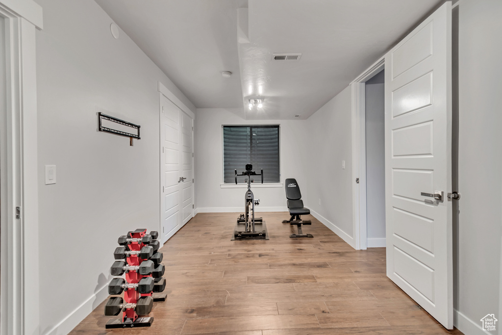 Workout room featuring light wood-type flooring