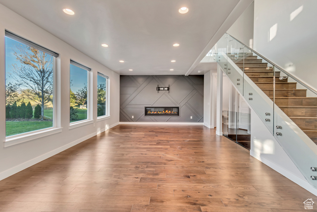 Unfurnished living room with dark wood-type flooring