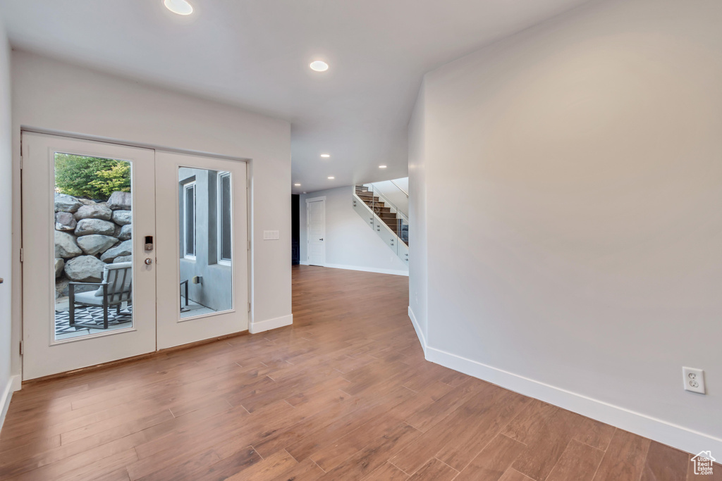 Entrance foyer featuring french doors and hardwood / wood-style flooring